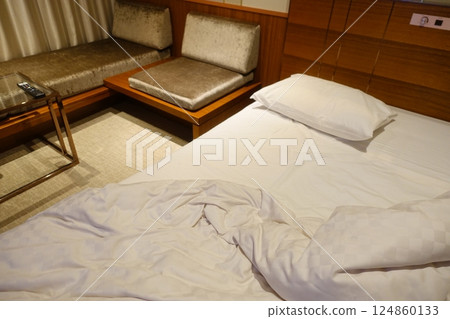 Messy hotel bed at checkout 124860133