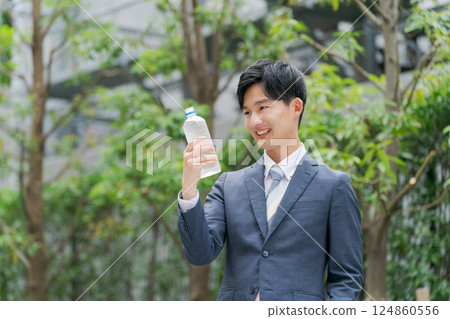A businessman making rounds in the heat A businessman making rounds in the heat 124860556