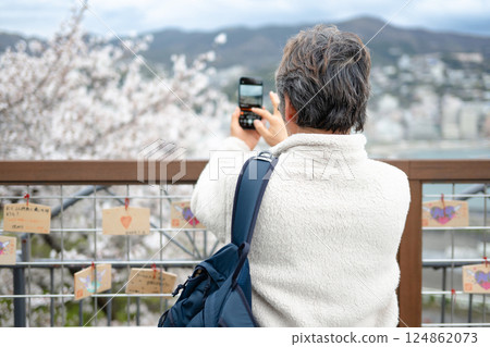 man taking photo with smartphone 124862073