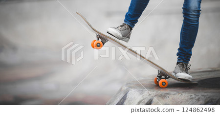 Skateboarder skateboarding at skatepark in city 124862498