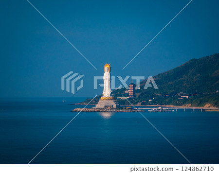 Guanyin statue at seaside in nanshan temple, hainan island , China. Words mean mercy and blessing. 124862710