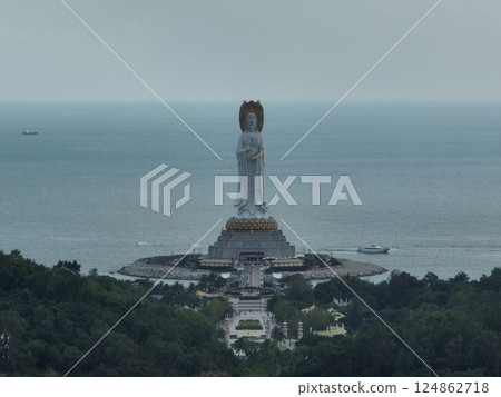 Guanyin statue at seaside in nanshan temple, hainan island , China. Words mean mercy and blessing. 124862718
