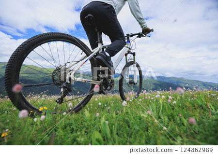 Riding mountain bike on grassland mountain top 124862989