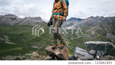 Woman hiker hiking in winter hugh glacier mountain,China Woman hiker hiking in winter hugh glacier mountain,China 124862991
