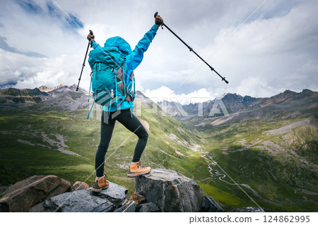 Hiking woman on high altitude mountain top Hiking woman on high altitude mountain top 124862995
