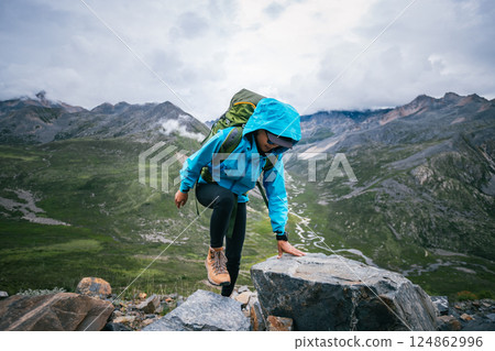 Hiking woman on high altitude mountain top 124862996