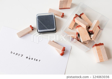 Happy Easter letter stamping with wooden blocks and ink pad Happy Easter letter stamping with wooden blocks and ink pad 124863036