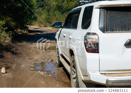 Driving off road car on the high altitude forest mountain 124863111