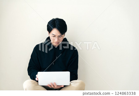 Man using a computer by the wall 124863338