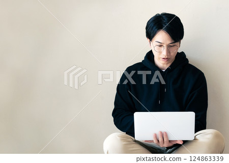 Man using a computer by the wall 124863339
