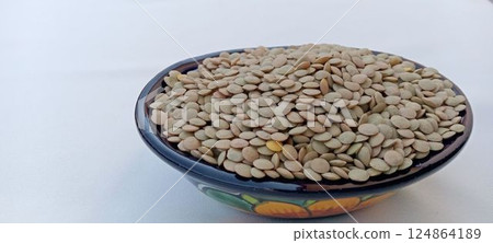 A bowl full of lentils (copy space, light blue background) 124864189