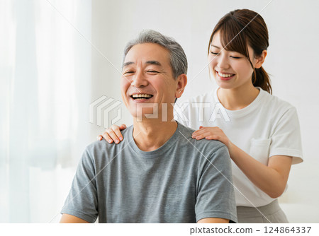 A father getting a shoulder massage from his daughter 124864337