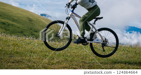 Jumping mountain bike in the beautiful mountains Jumping mountain bike in the beautiful mountains 124864664