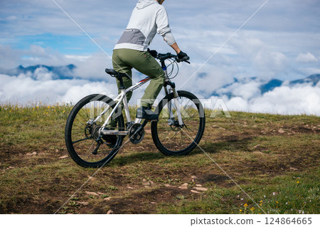 Riding mountain bike on beautiful mountain top 124864665