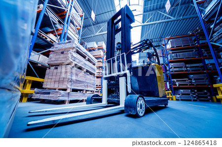 Forklift loader in storage warehouse ship yard. Distribution products. Delivery 124865418