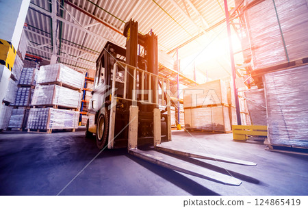 Forklift loader in storage warehouse ship yard. Distribution products. Delivery 124865419