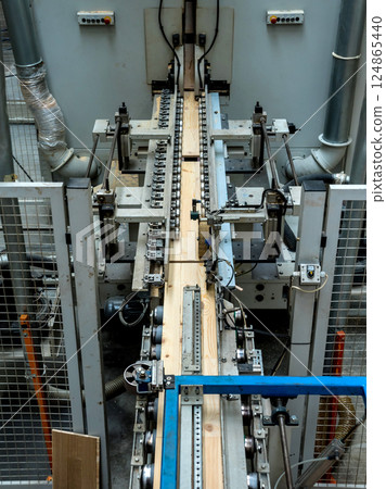 Production line of the wooden floor factory. CNC automatic woodworking machine. 124865440