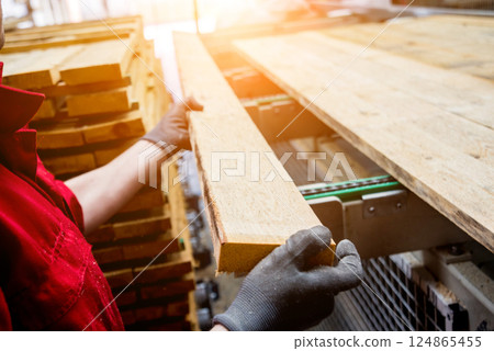 Carpenter with fibreboards at furniture factory workshop. Woodworking industry 124865455
