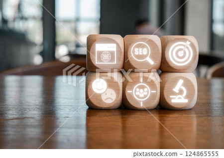 Creative representation of video marketing using digital icons on wooden blocks, symbolizing modern advertising techniques. 124865555