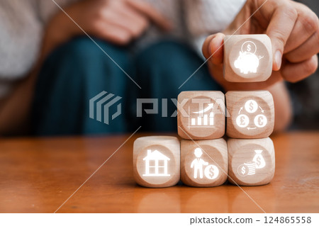 Conceptual image of retirement planning with financial symbols on wooden blocks, representing investment and savings strategies. 124865558