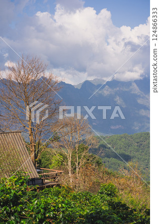 landscape and travel concept with sunlight and cloudy sky with country house on mountain 124866333