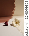 On the table, there is a beautiful heart and a vibrant flower 124866606