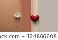 A red heart hangs on a wall next to a lovely white flower 124866608