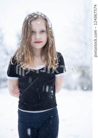 A little beautiful girl with blue eyes, a blonde, in the cold, in a T-shirt, is hardening herself A little beautiful girl with blue eyes, a blonde, in the cold, in a T-shirt, is hardening herself 124867574