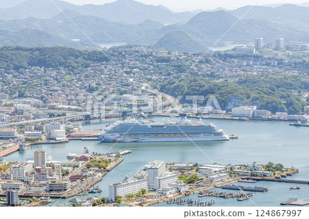 Sasebo City, Nagasaki Prefecture: Streets of Sasebo City with a large cruise ship anchored Sasebo City, Nagasaki Prefecture: Streets of Sasebo City with a large cruise ship anchored 124867997