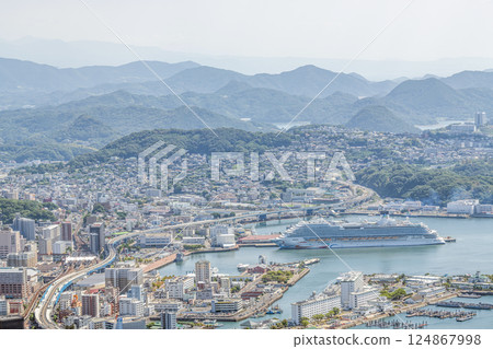 Sasebo City, Nagasaki Prefecture: Streets of Sasebo City with a large cruise ship anchored 124867998