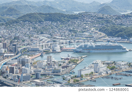Sasebo City, Nagasaki Prefecture: Streets of Sasebo City with a large cruise ship anchored 124868001