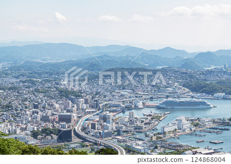 Sasebo City, Nagasaki Prefecture: Streets of Sasebo City with a large cruise ship anchored 124868004