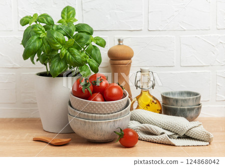 Fresh cherry tomatoes and basil creating a vibrant culinary scene 124868042
