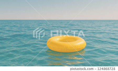 A yellow swim ring floating in the midsummer sea 124868728