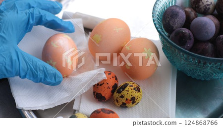 Coloring Easter eggs with pearl paint and decorating eggs in vibrant colors for holiday fun Coloring Easter eggs with pearl paint and decorating eggs in vibrant colors for holiday fun 124868766