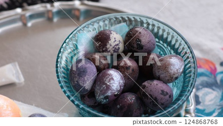 Decorating Easter eggs with vibrant purple shades using coloring techniques for a festive celebration Decorating Easter eggs with vibrant purple shades using coloring techniques for a festive celebration 124868768