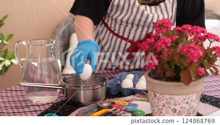 Creating vibrant Easter eggs through coloring activities with various tools and natural materials, perfect for family fun during the festive season 124868769