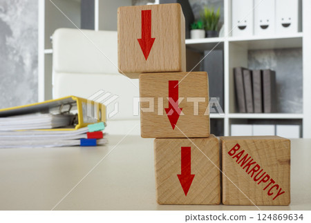 Downward arrows and the word bankruptcy. 124869634