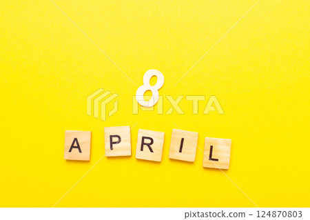 8 April calendar date made by wooden cubes on yellow color background. 124870803