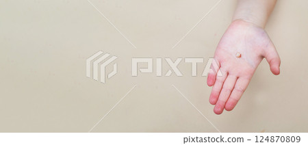 Little girl's hand holding and showing her fallen milk front tooth close up. Little girl's hand holding and showing her fallen milk front tooth close up. 124870809