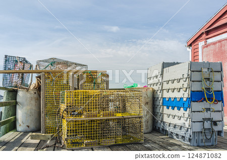 Lobster traps and fishing equipment on a pier in Maine, USA 124871082