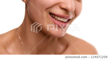 Cropped close-up image of young, smiling, beautiful woman with flawless, spotless skin, plump lips and white teeth. Cropped close-up image of young, smiling, beautiful woman with flawless, spotless skin, plump lips and white teeth. 124871209