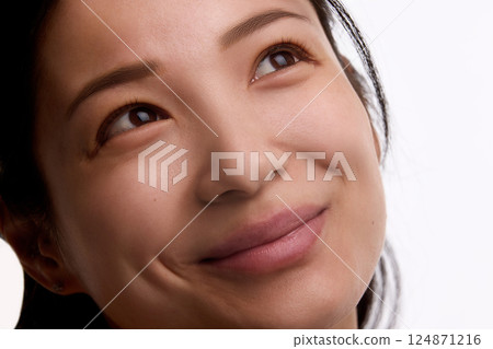 Close-up of portrait of smiling Korean woman in her 20s with glowing complexion and healthy skin texture isolated on white background Close-up of portrait of smiling Korean woman in her 20s with glowing complexion and healthy skin texture isolated on white background 124871216