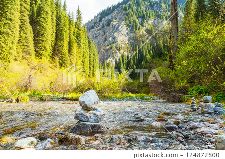 pyramid of river stones on the river bank. A tower of stones in the forest pyramid of river stones on the river bank. A tower of stones in the forest 124872800