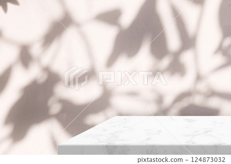 Minimal White Marble Table Corner with Shadow and Warm Light Beam on Concrete Wall Background 124873032