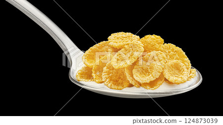 Corn flakes on spoon with yogurt isolated on black background, package design element Corn flakes on spoon with yogurt isolated on black background, package design element 124873039