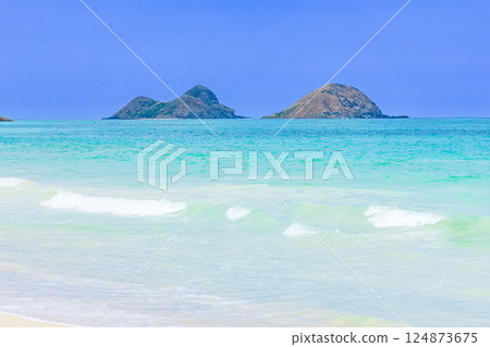 Hawaiian Holidays: Mokulua Islands as seen from Bellows Beach on Oahu Hawaiian Holidays: Mokulua Islands as seen from Bellows Beach on Oahu 124873675