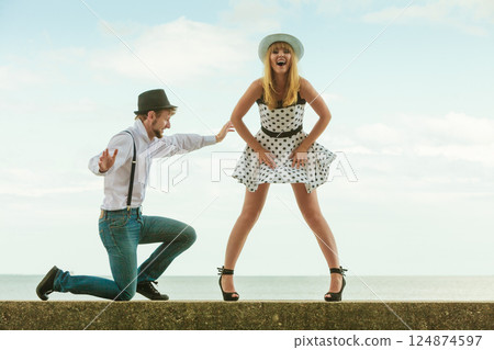 Loving couple retro style dating on sea coast Loving couple retro style dating on sea coast 124874597