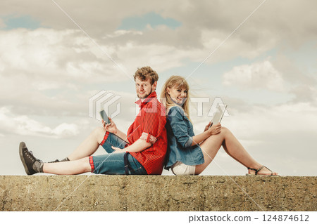 woman with smartphone man with tablet couple outdoor 124874612