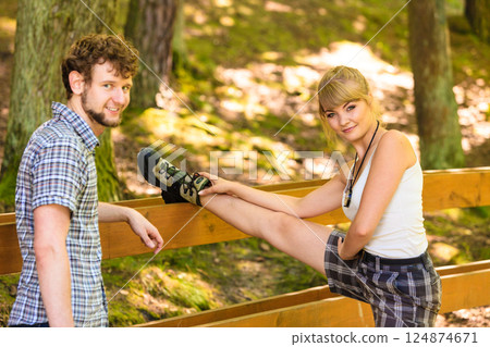 Hiker young couple in nature preparing to hike 124874671